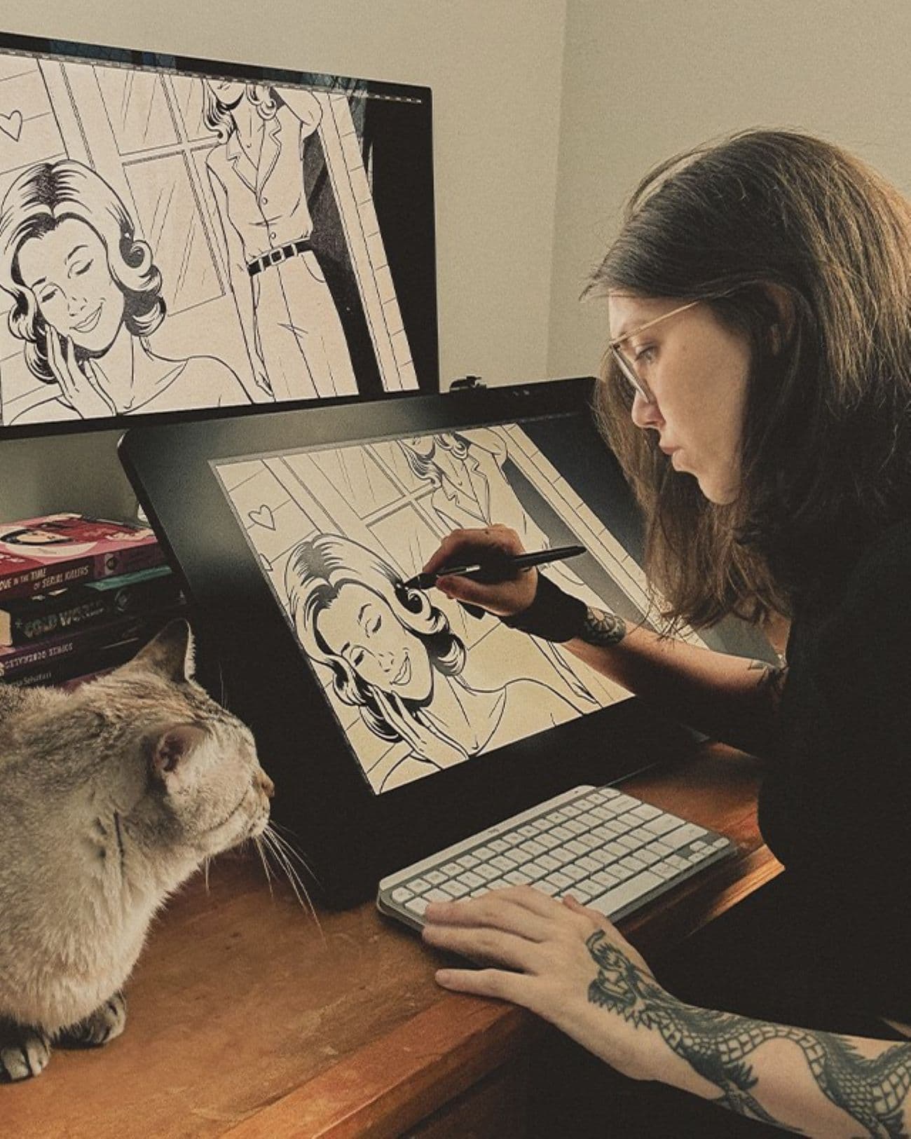 Jenifer Prince drawing with her cat watching on