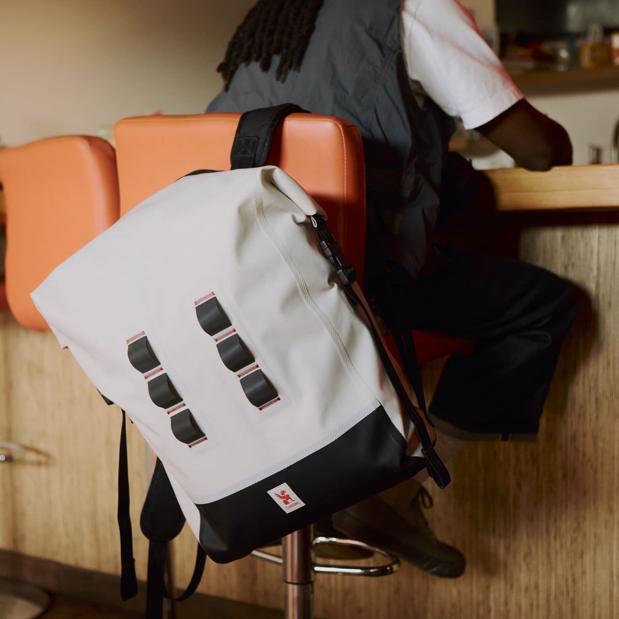 A guy sitting at the bar with the 30L Future White Urban Ex #color_future white