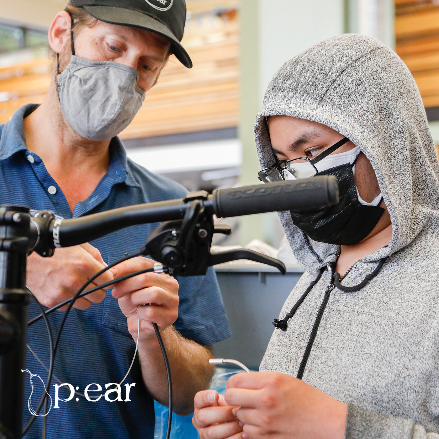 p:ear crew working on a bicycle