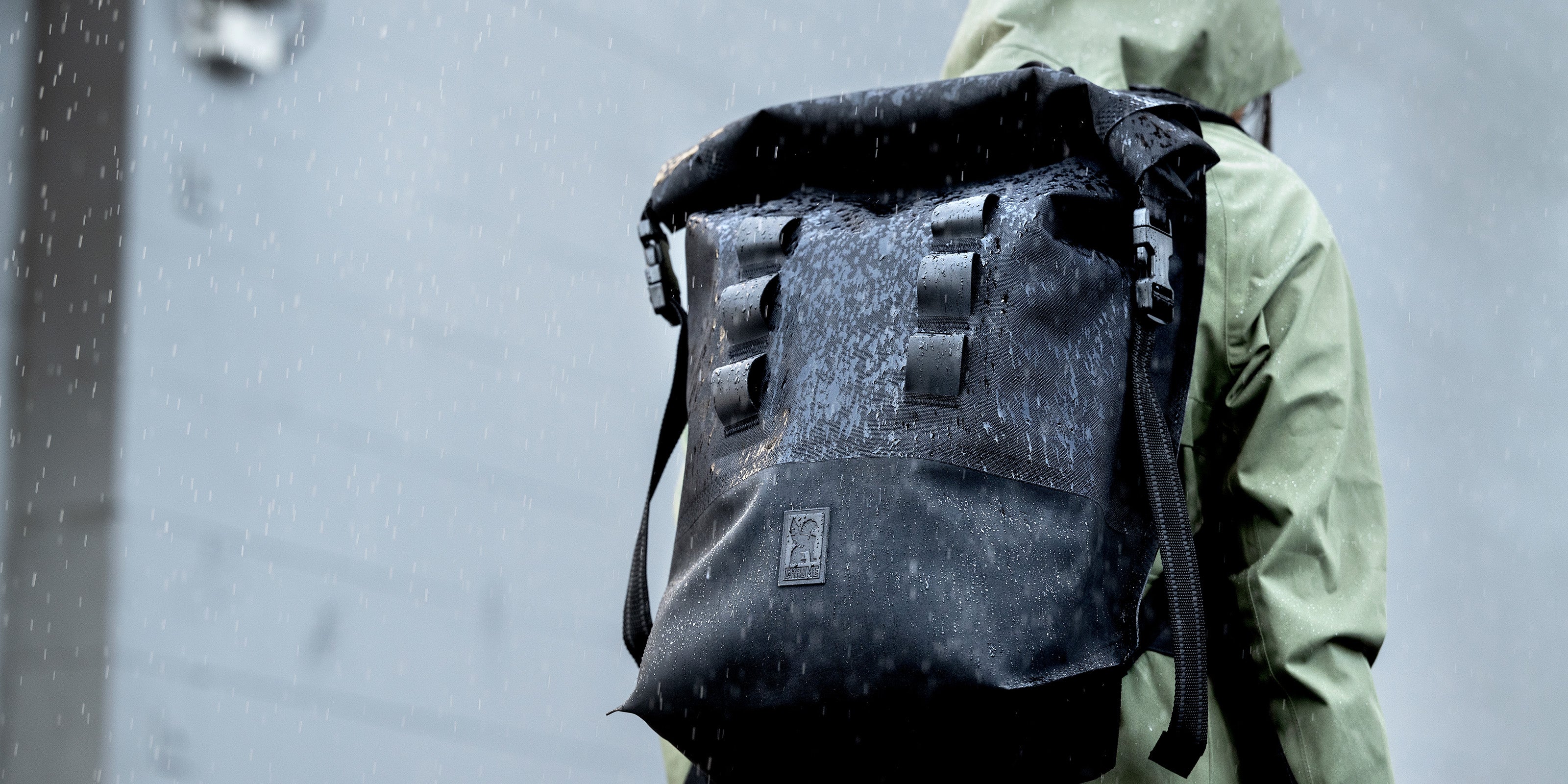 Waterproof Urban Ex 30L shown in the rain desktop banner size